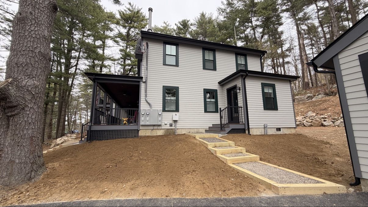 Finished home with gravel steps and landscaped terraces